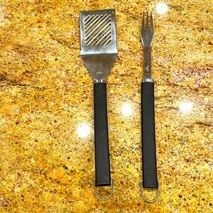 TWO GRILL TOOLS- STAINLESS STEEL WITH BLACK HANDLES- KNIFE EDGE SPATULA AND FORK
